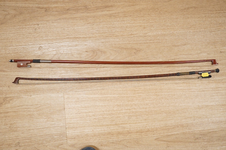 A late 19th century German violin, body 35cm long, and two bows. Condition - poor to fair.